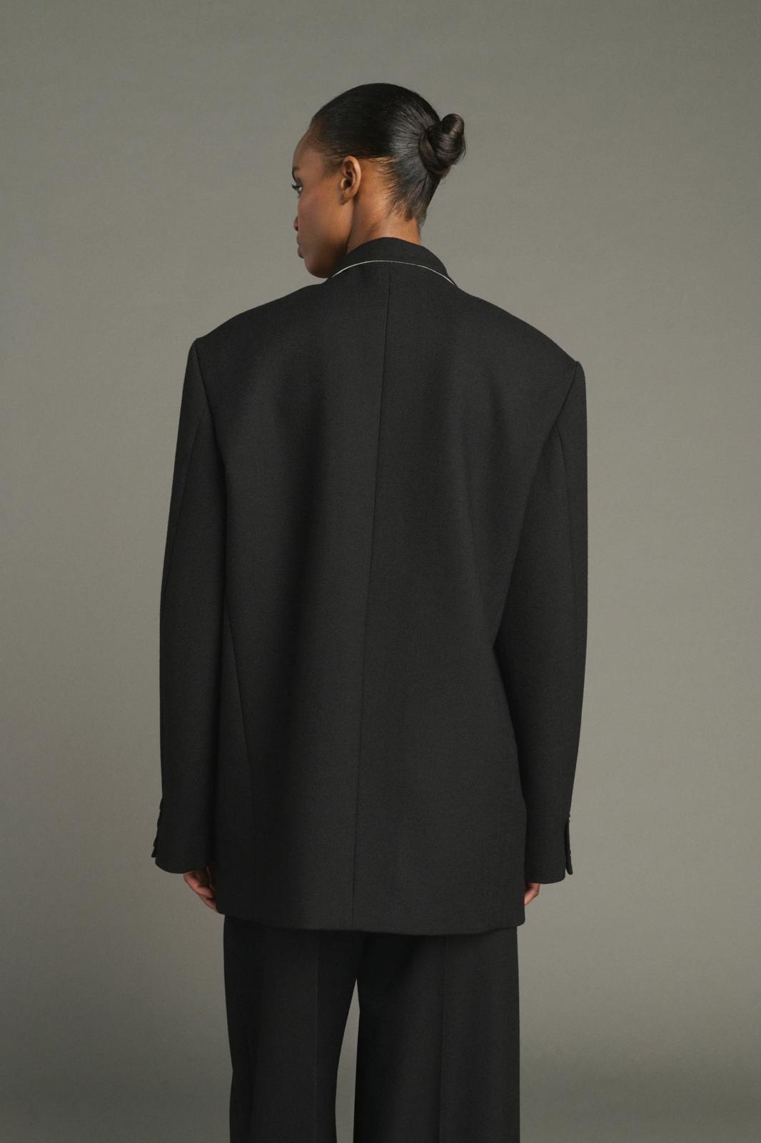 Lars coat                                   Oversized beige jacket with turned down collar